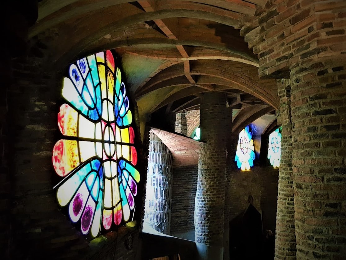 Stained-glass and columns on the Colonia Guell church, crypt by Antoni Gaudí. Barcelona.