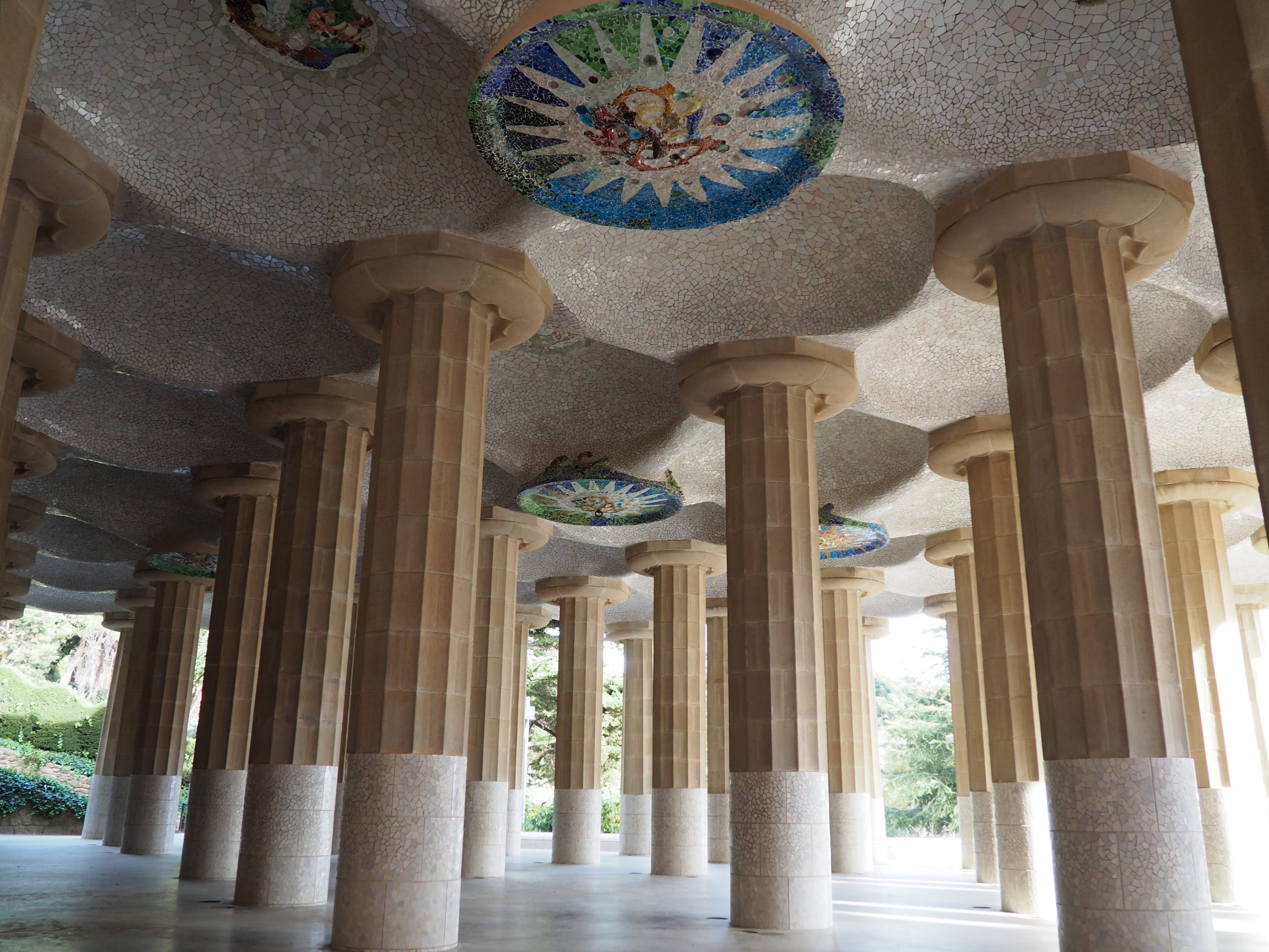 Columns room with mosaics on the ceiling representing the four seasons. Park Güell, Barcelona for kids.