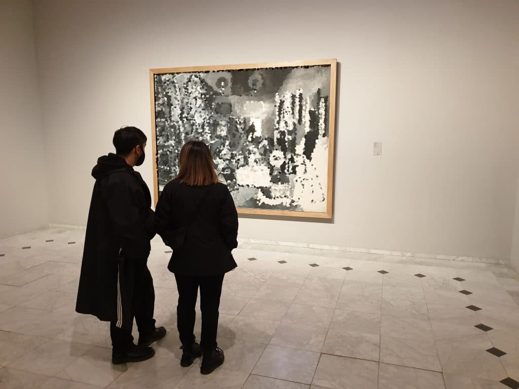 Two persons looking at a Picasso painting during a private tour to the museum.